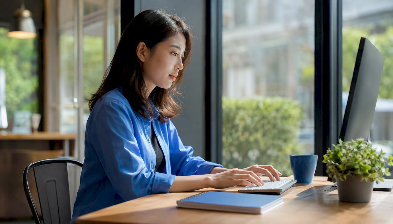 Hands typing at keyboard setting up BI dashboard