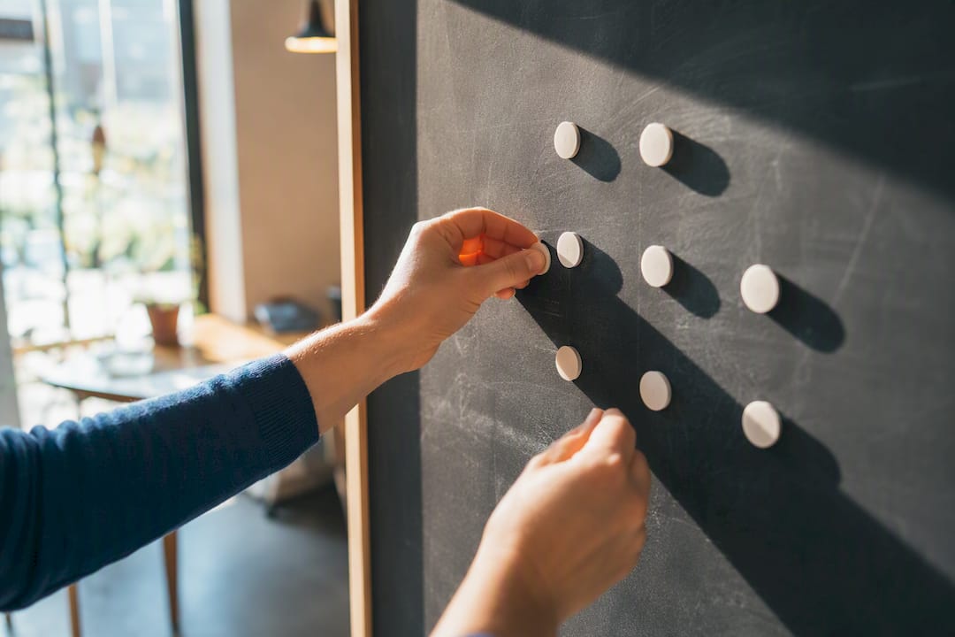Hands placing tokens on planning board