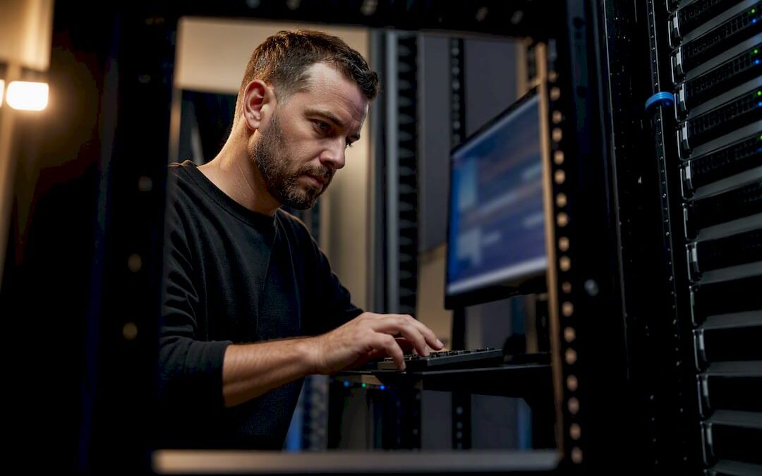 Technician carrying out website maintenance in server room